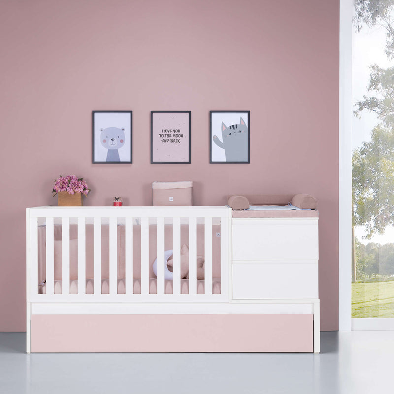 Cuna de bebé compacta con cama nido y cambiador, color rosa